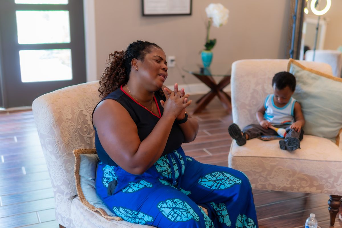Woman in deep prayer during the event